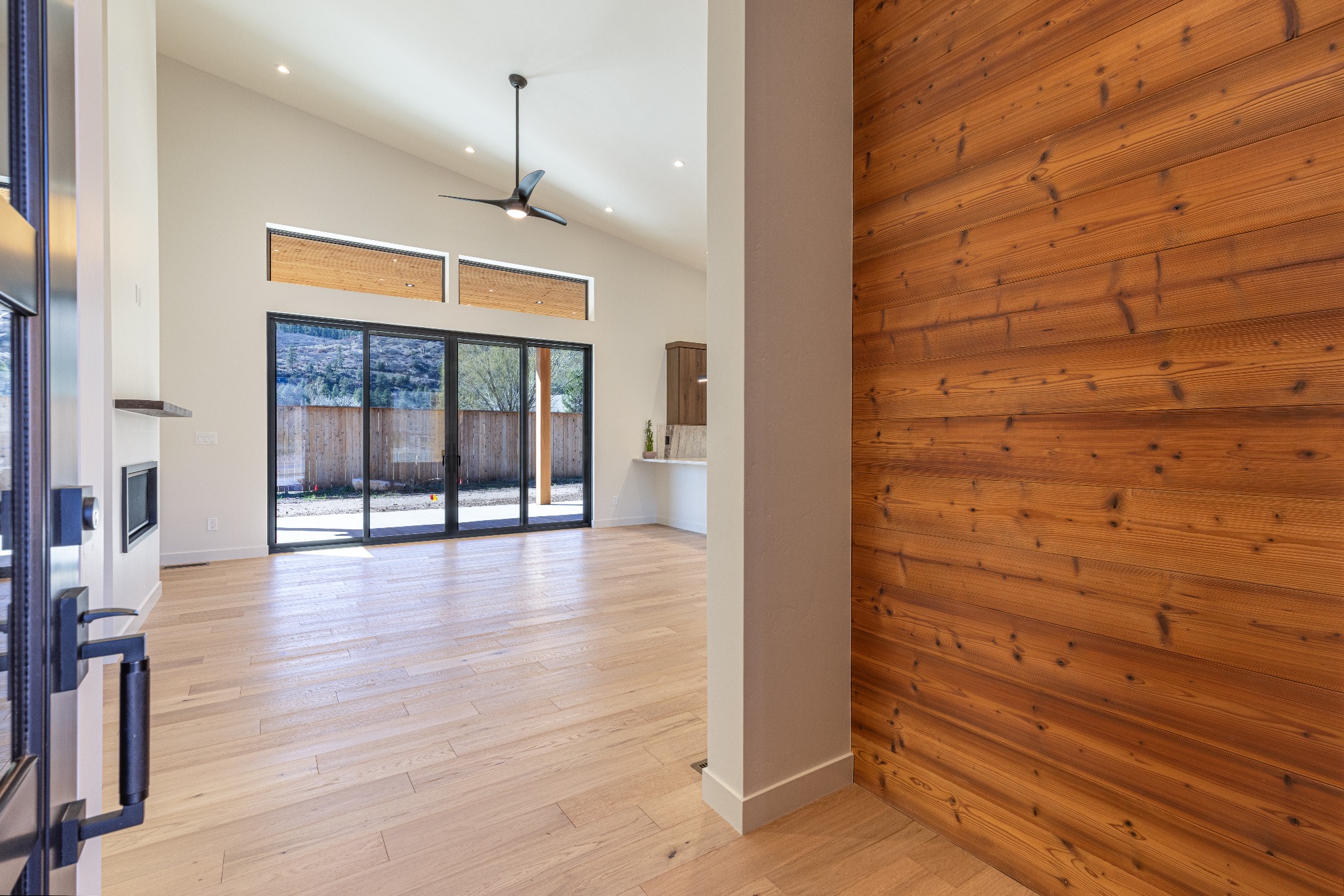 Light-filled living room and cedar entry wall